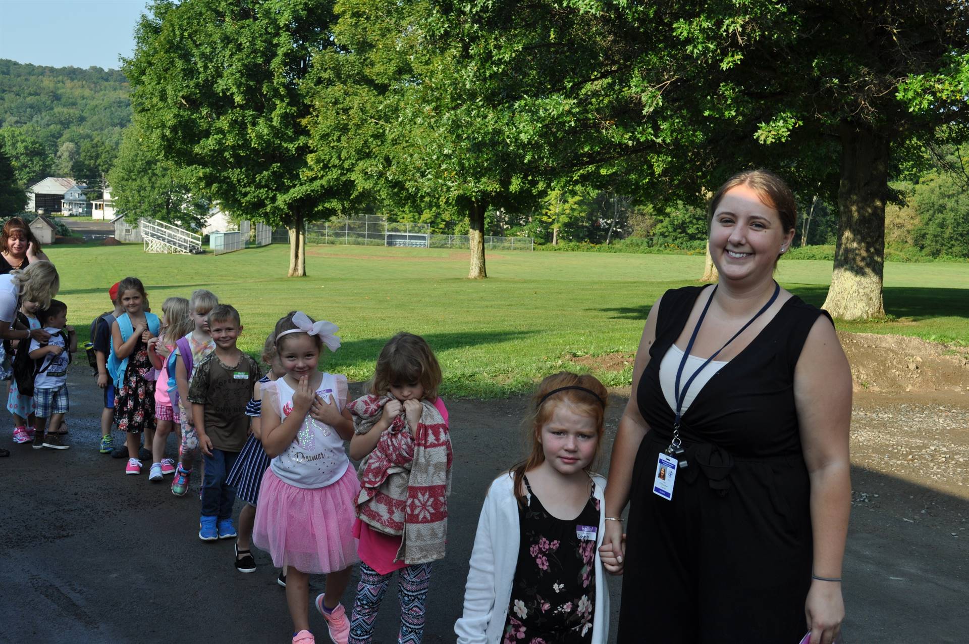 teachers and kids smile as they enter guilford!