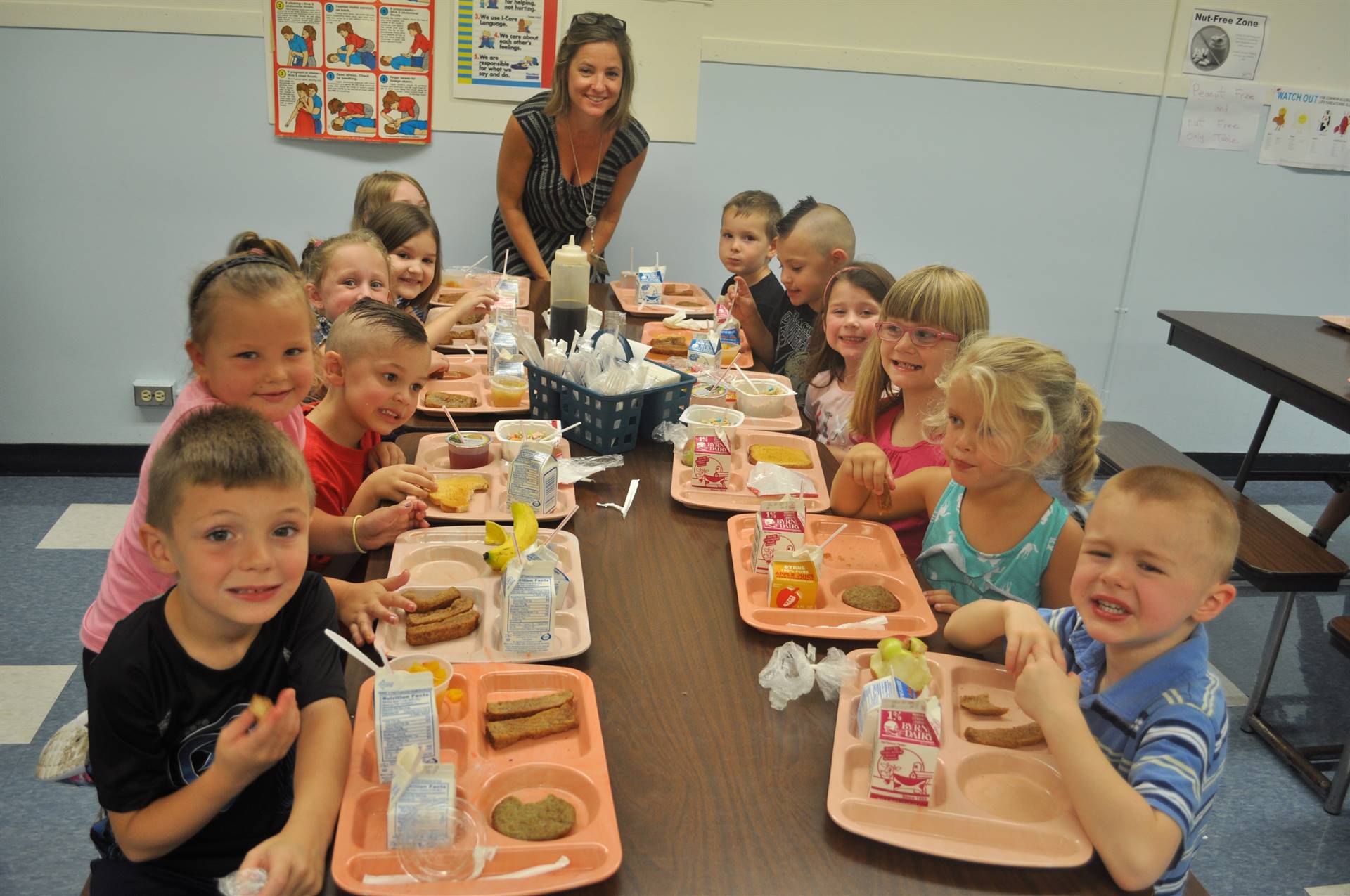 A teacher and students have breakfast