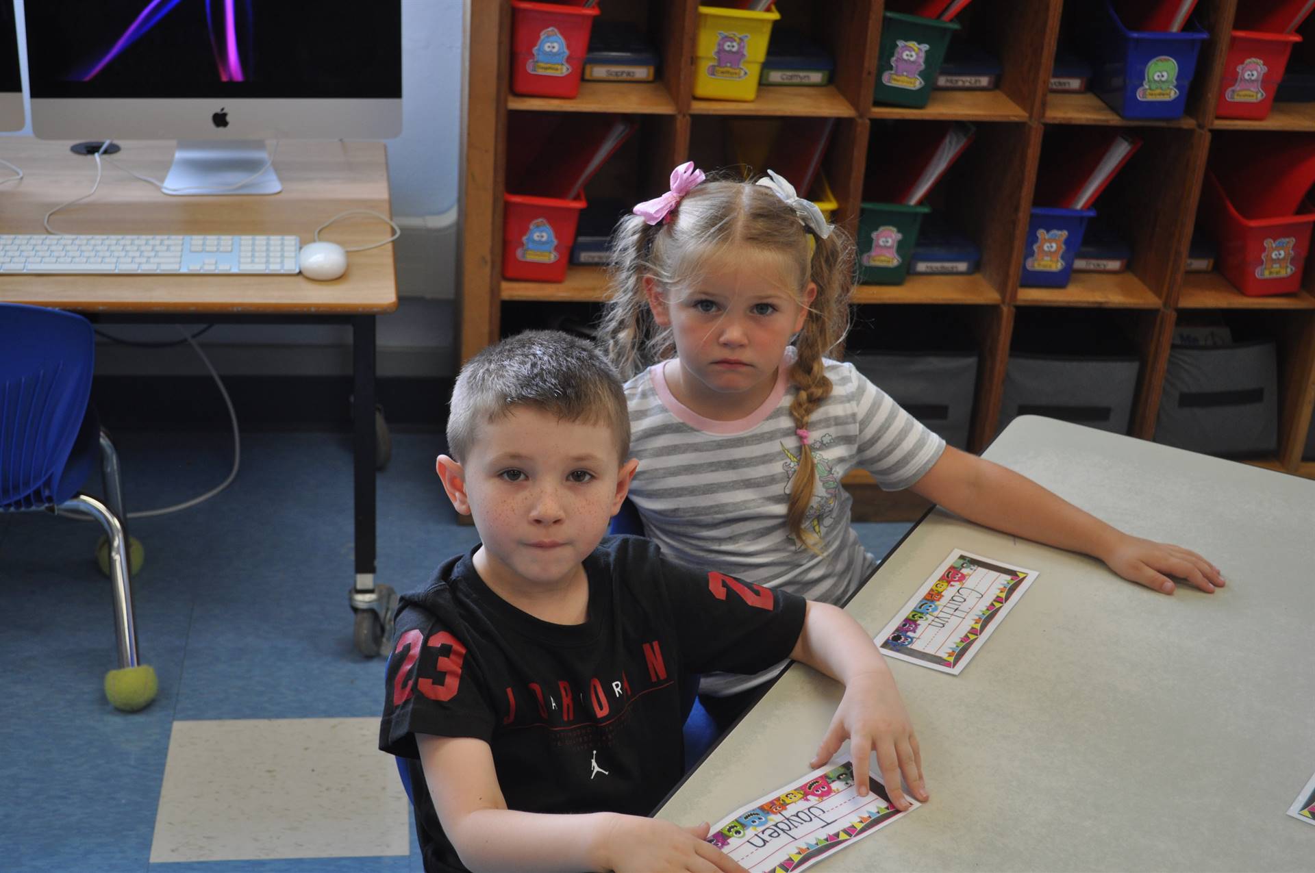 students sit at desk.