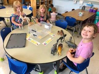 Students play together at a table.
