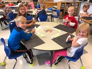 Kindergarteners learn how to glue!