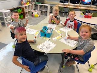 Kindergartners at a table.