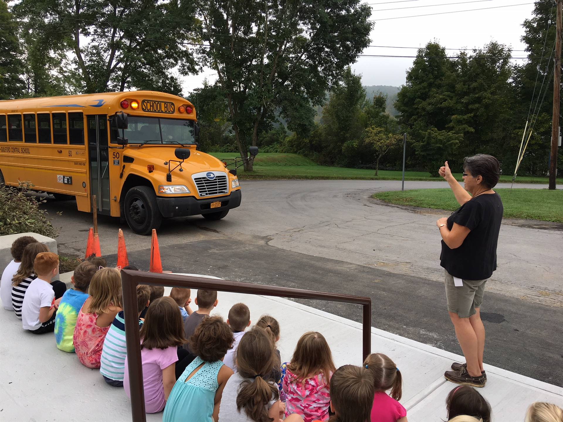 Bus driver talks about lights on the bus with students