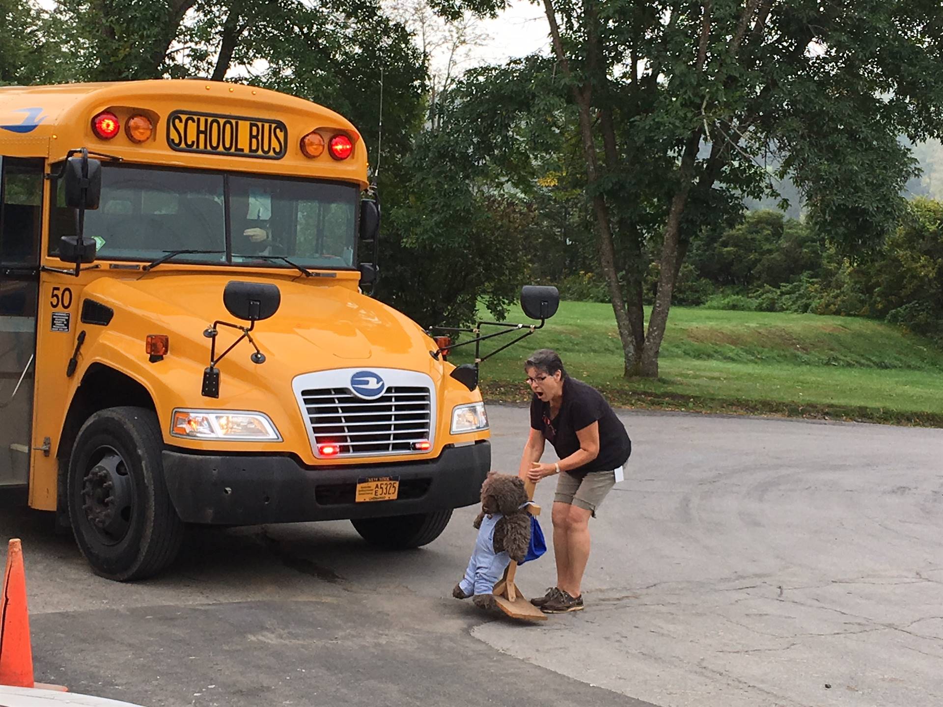 Bus driver with Becka Bear models safe road crossing.