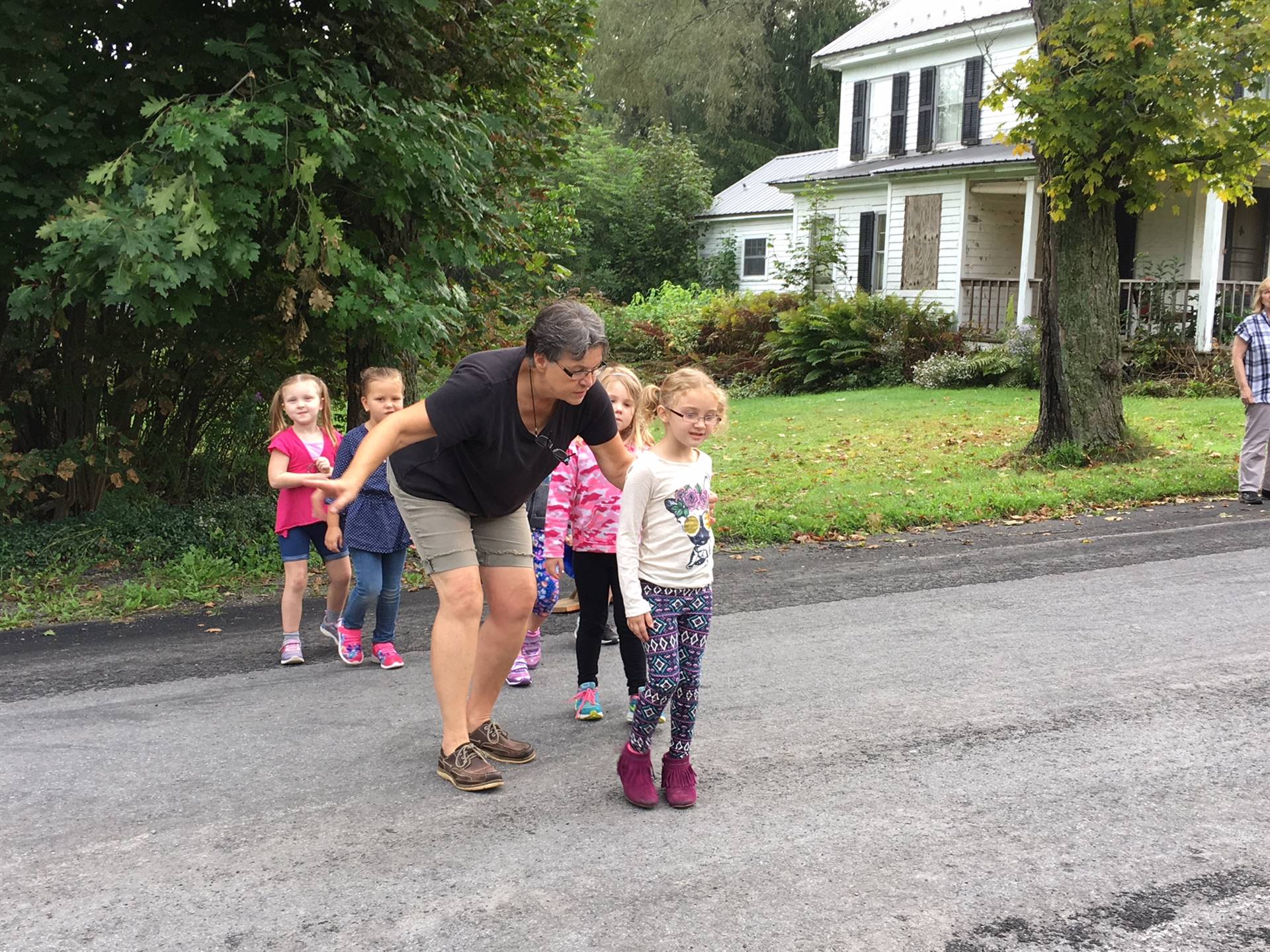 Bus driver and students model safe road crossing.