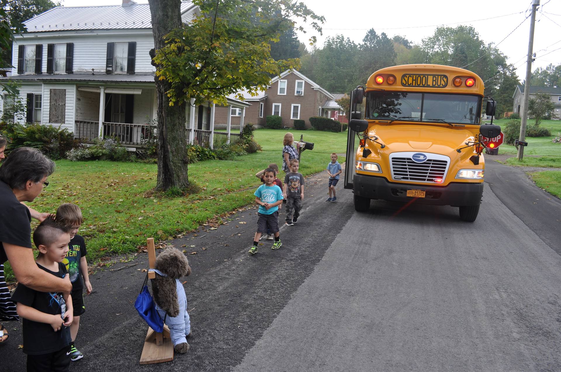 Students and bus driver practice getting on bus safely