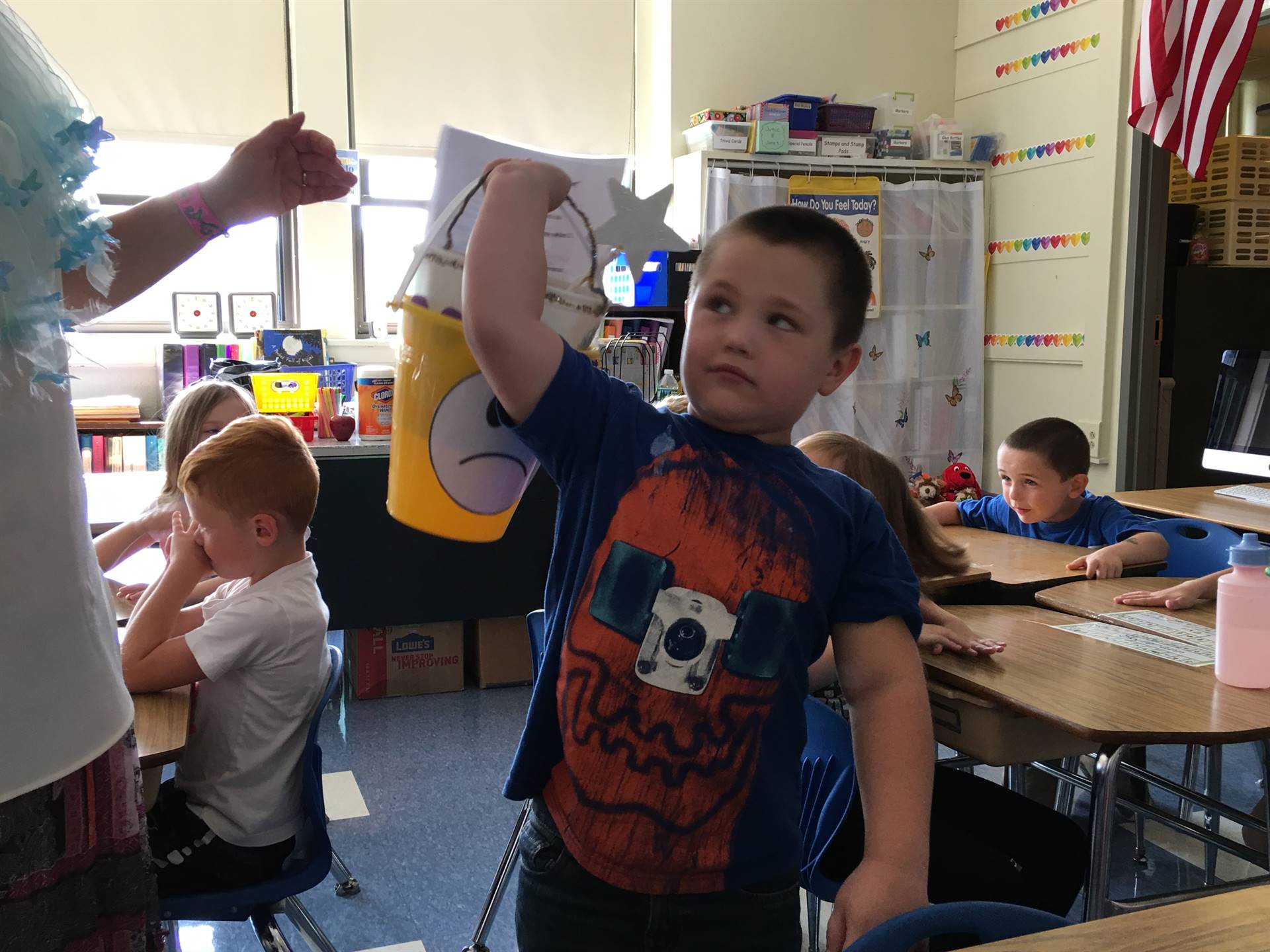 A student demonstrates how heavy a bucket is when feeling sad.