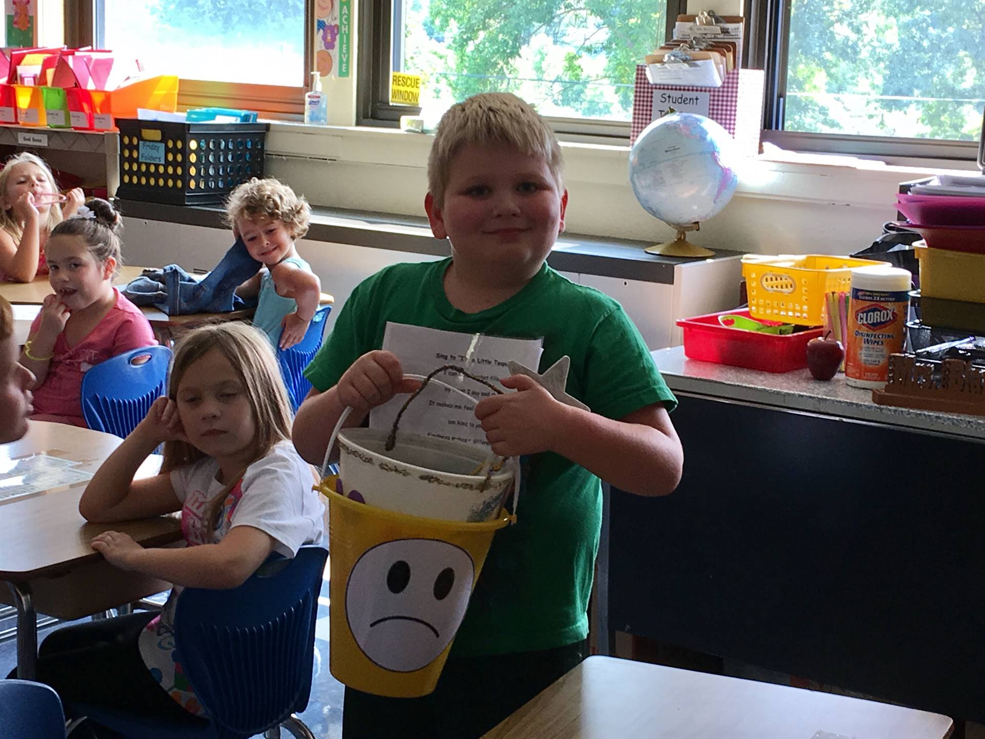 A student tries to lift a heavy bucket filled with sad feelings.