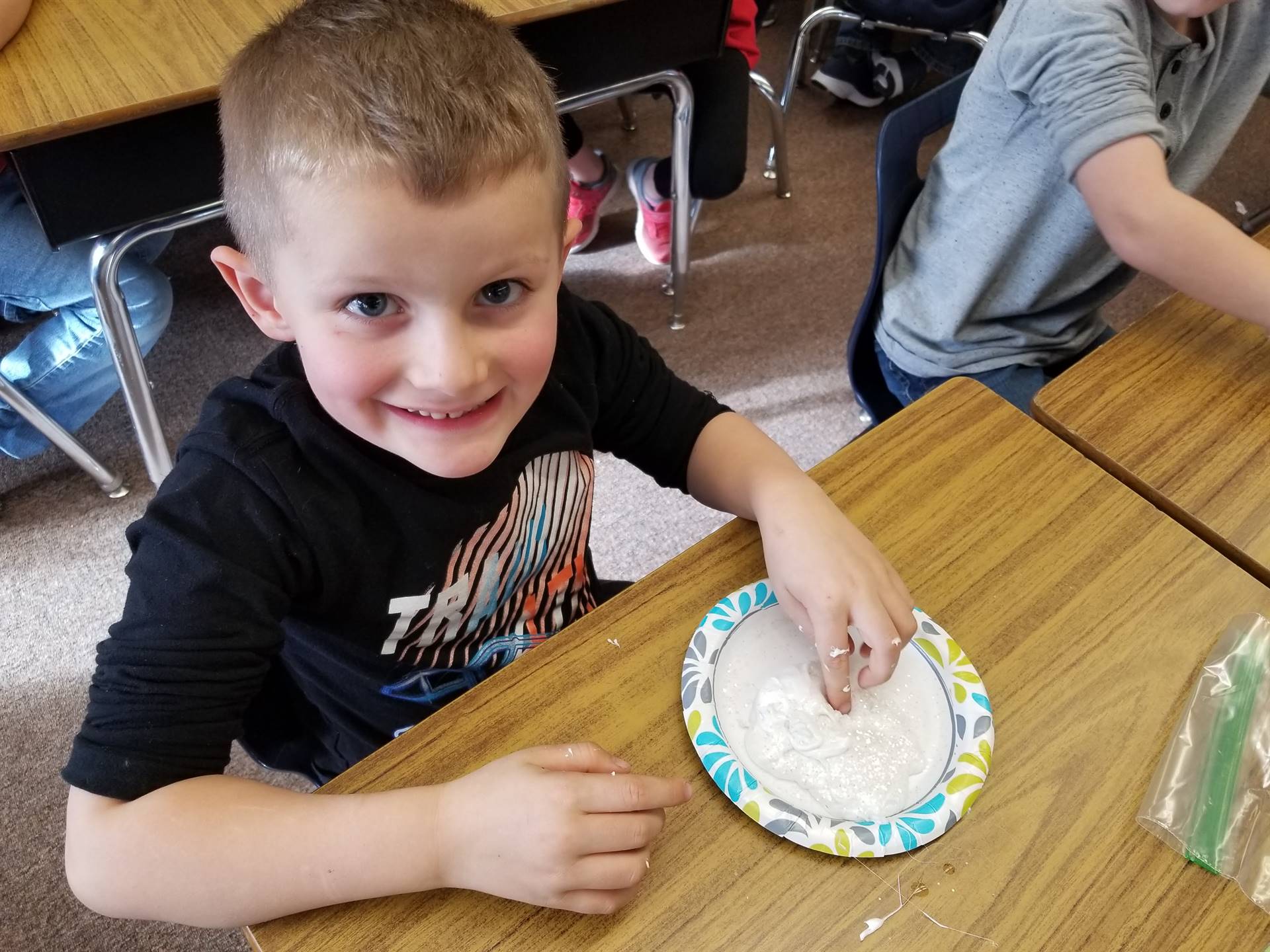 Student touches snow slime