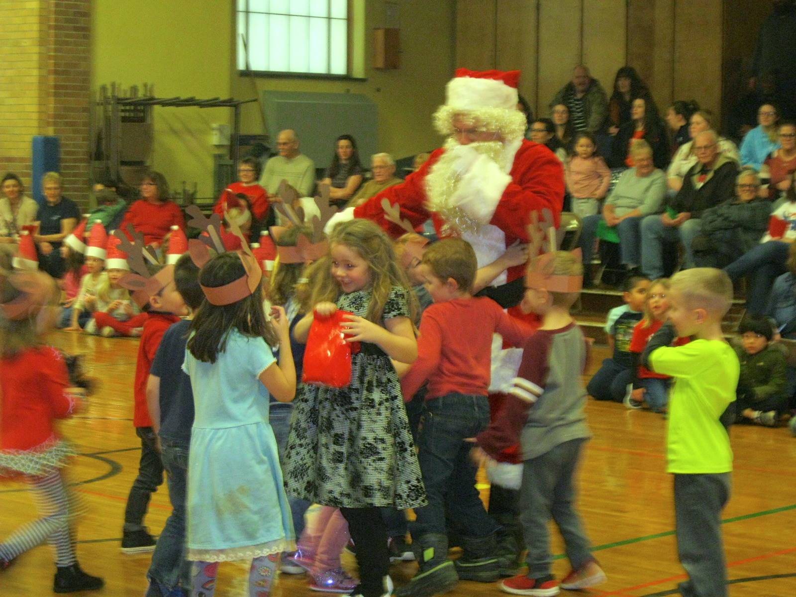 Students are gathered around Santa.