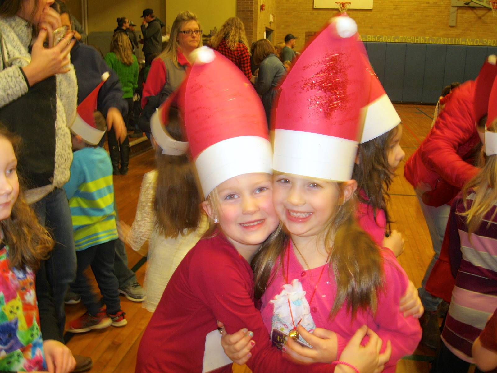 2 students with santa hats.