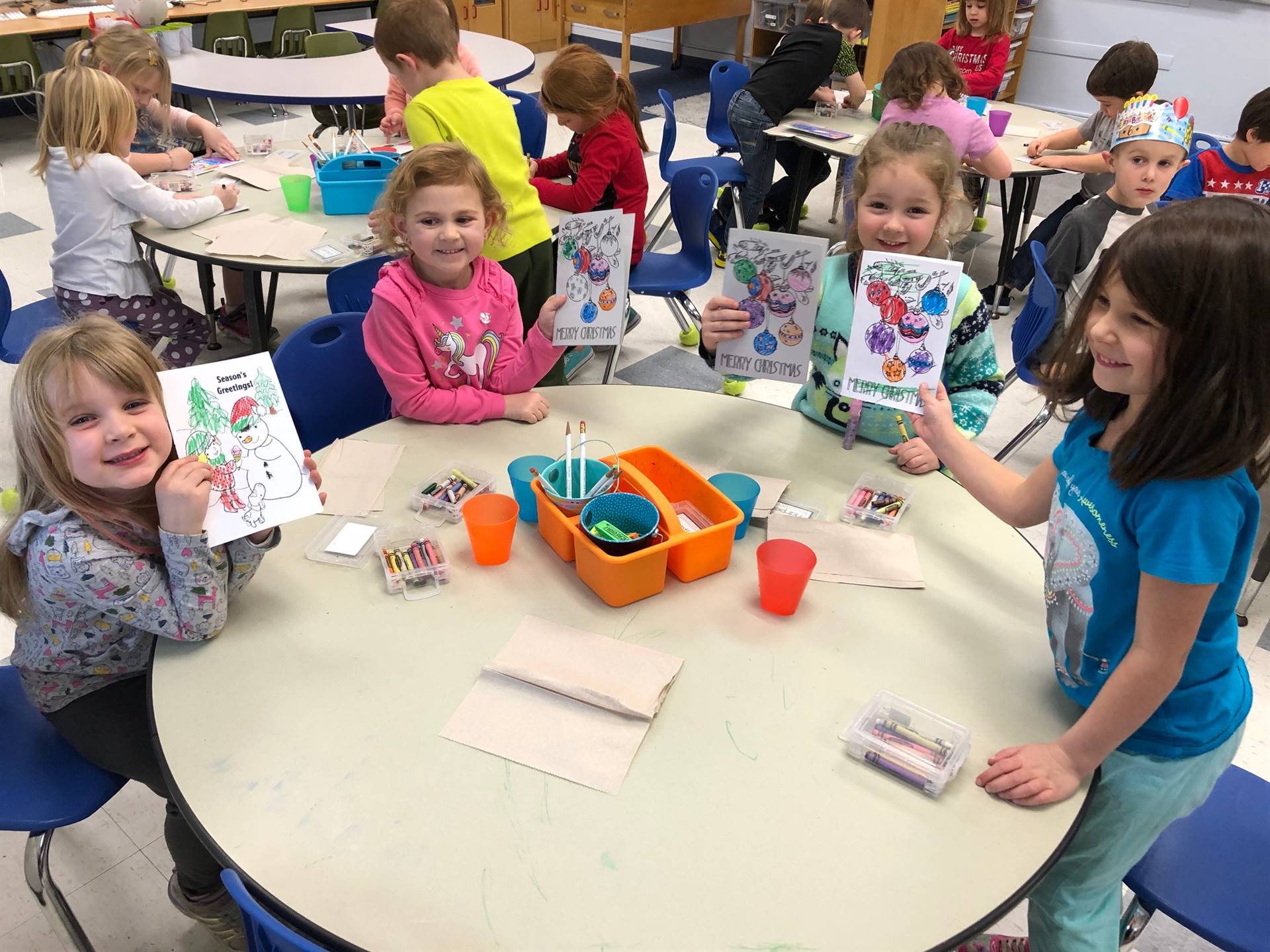 4 students smile and share cooling pages.