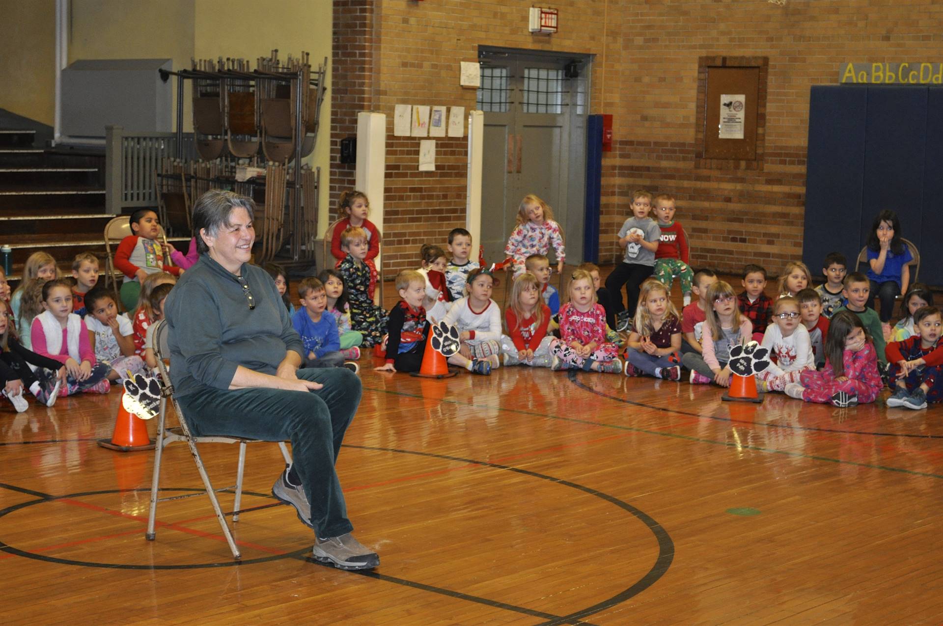 Mrs. Butcher and students listen to chant.