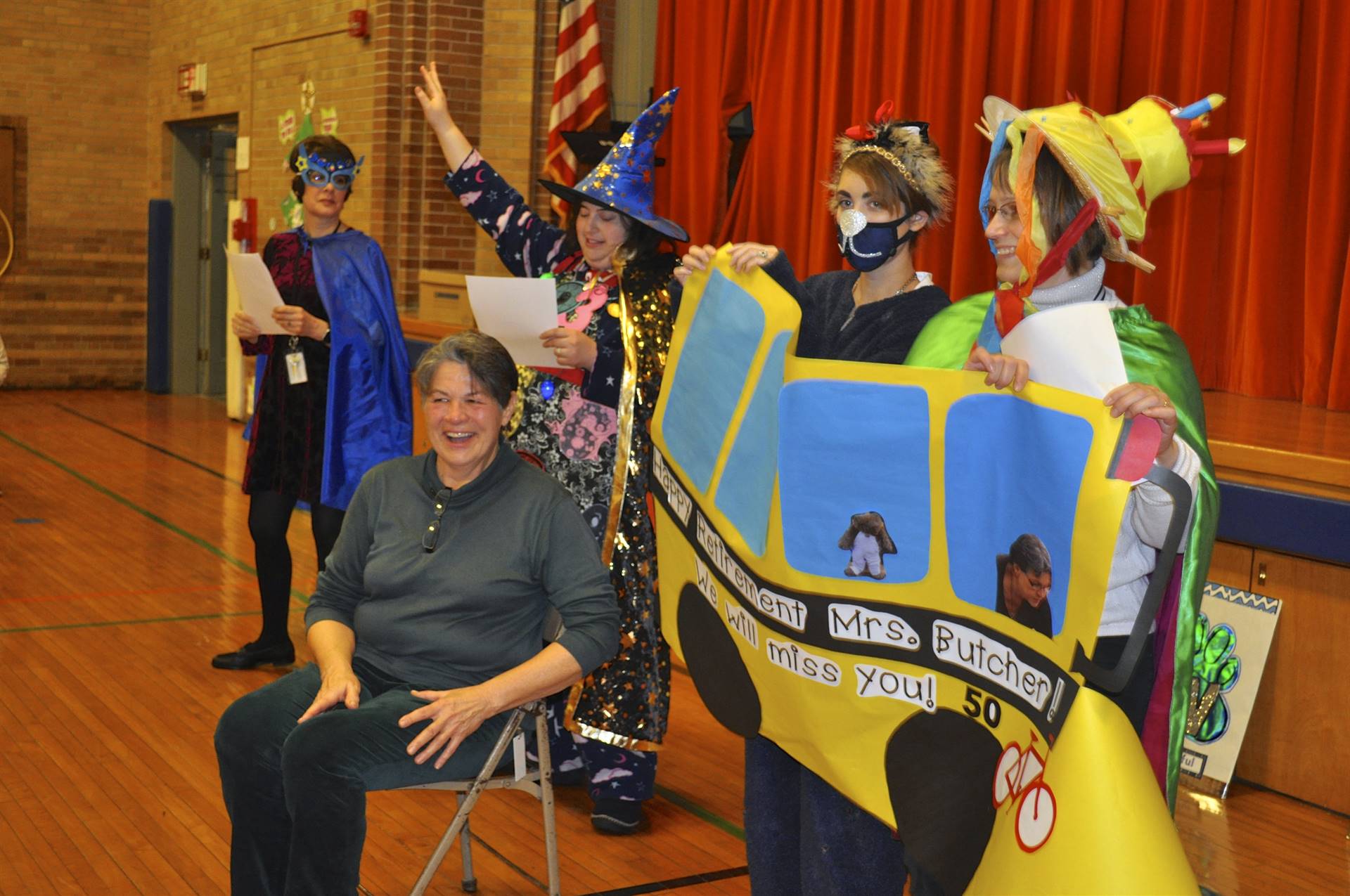 The PAWS superheros pose with Mrs. Butcher and a paper bus!