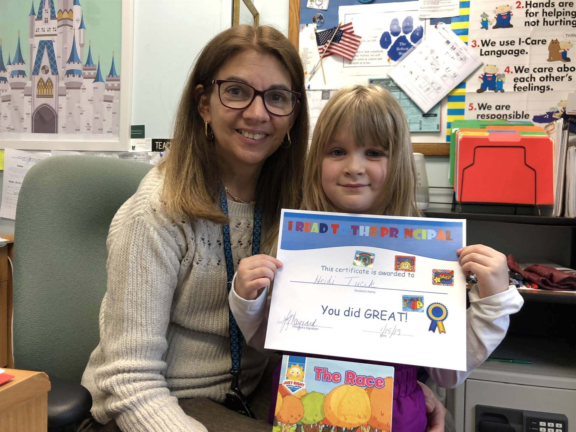 Principal with kindergarten reader.