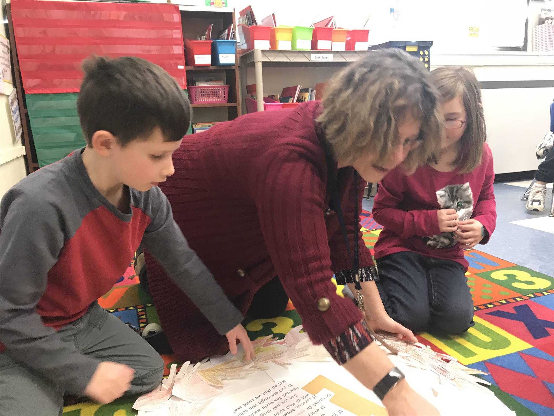 Counselor and student assembling "colors of us" wreath