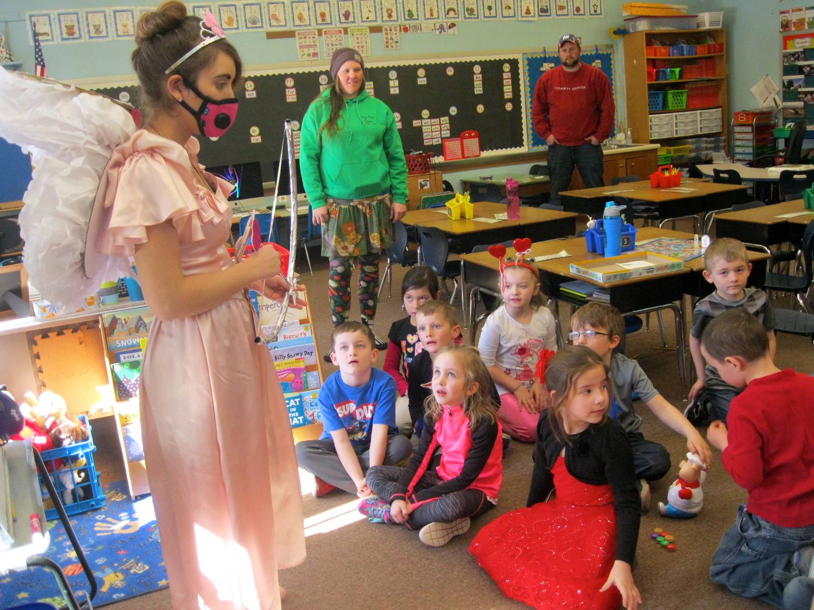 Cupid talks to a group of students about friendship.