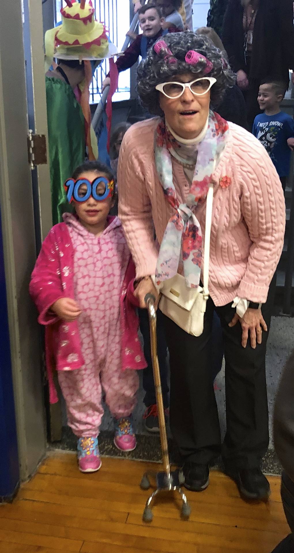 A teacher and student dressed as 100 yr. old.