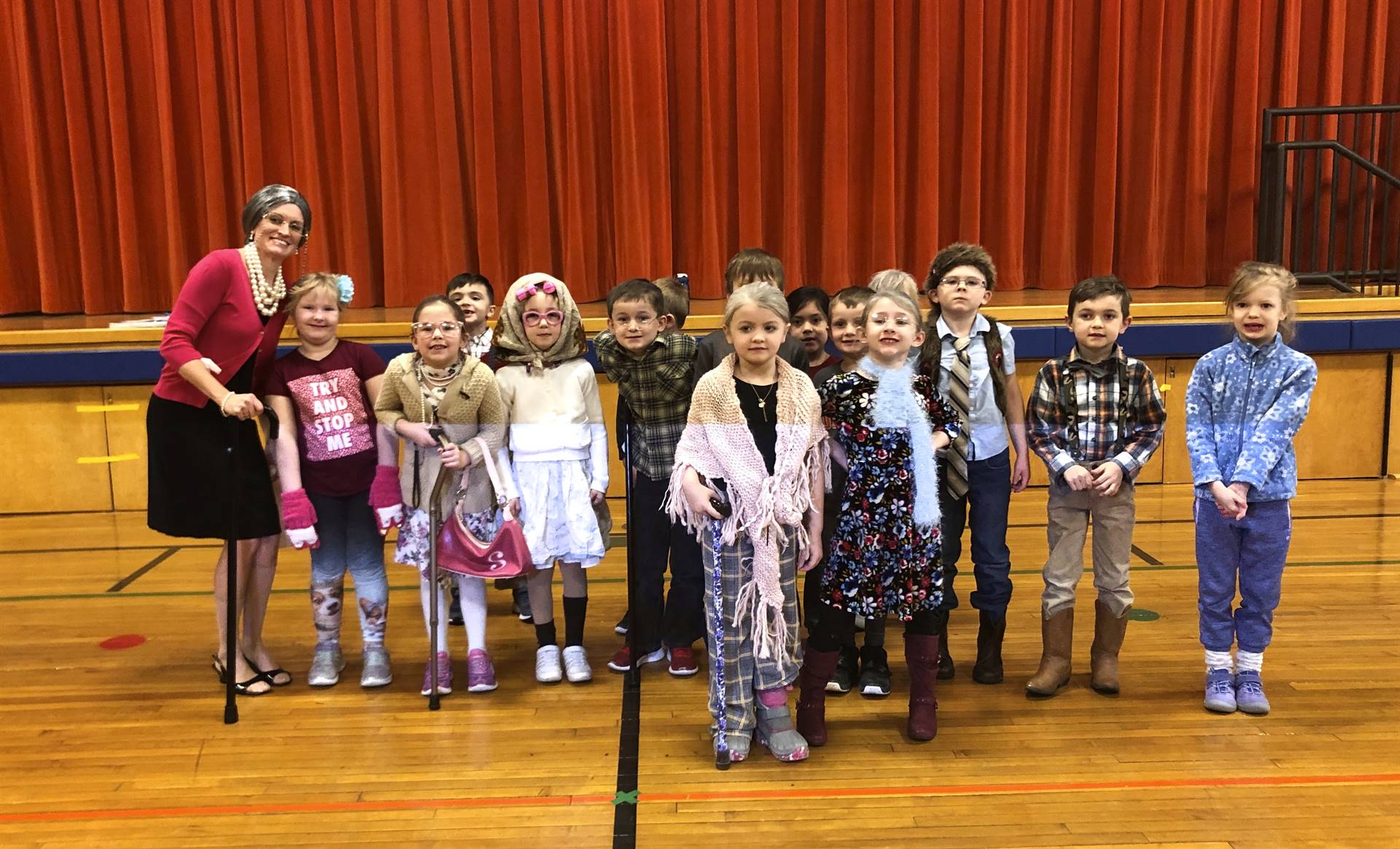 A teacher and her class on 100th day of school.