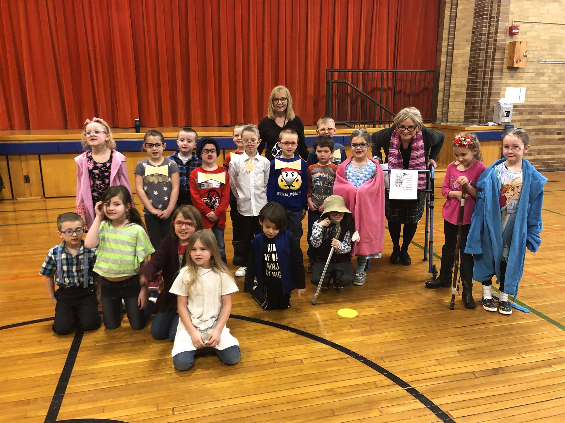 A teacher and her class on 100th day of school.