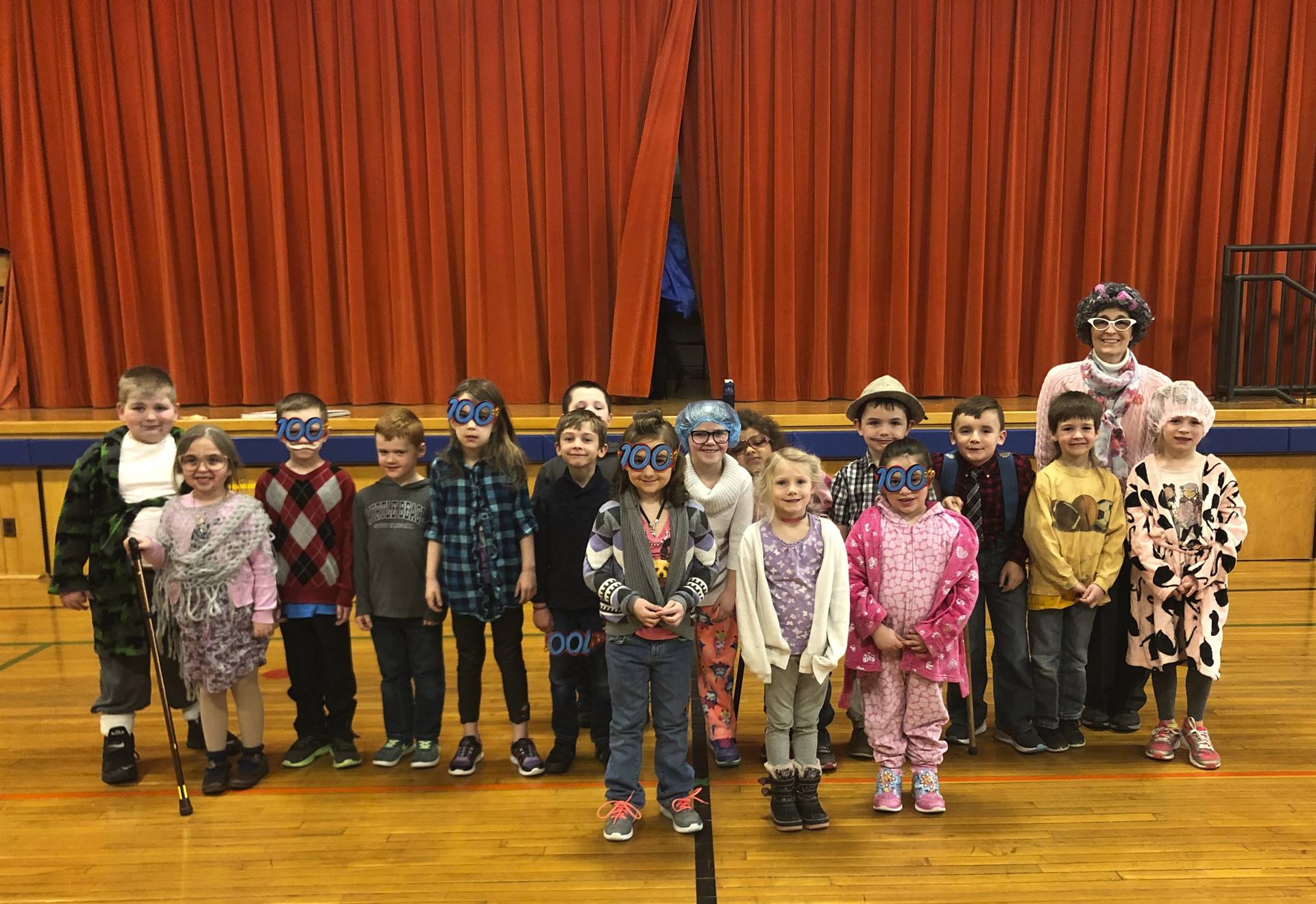 A teacher and her class on 100th day of school.