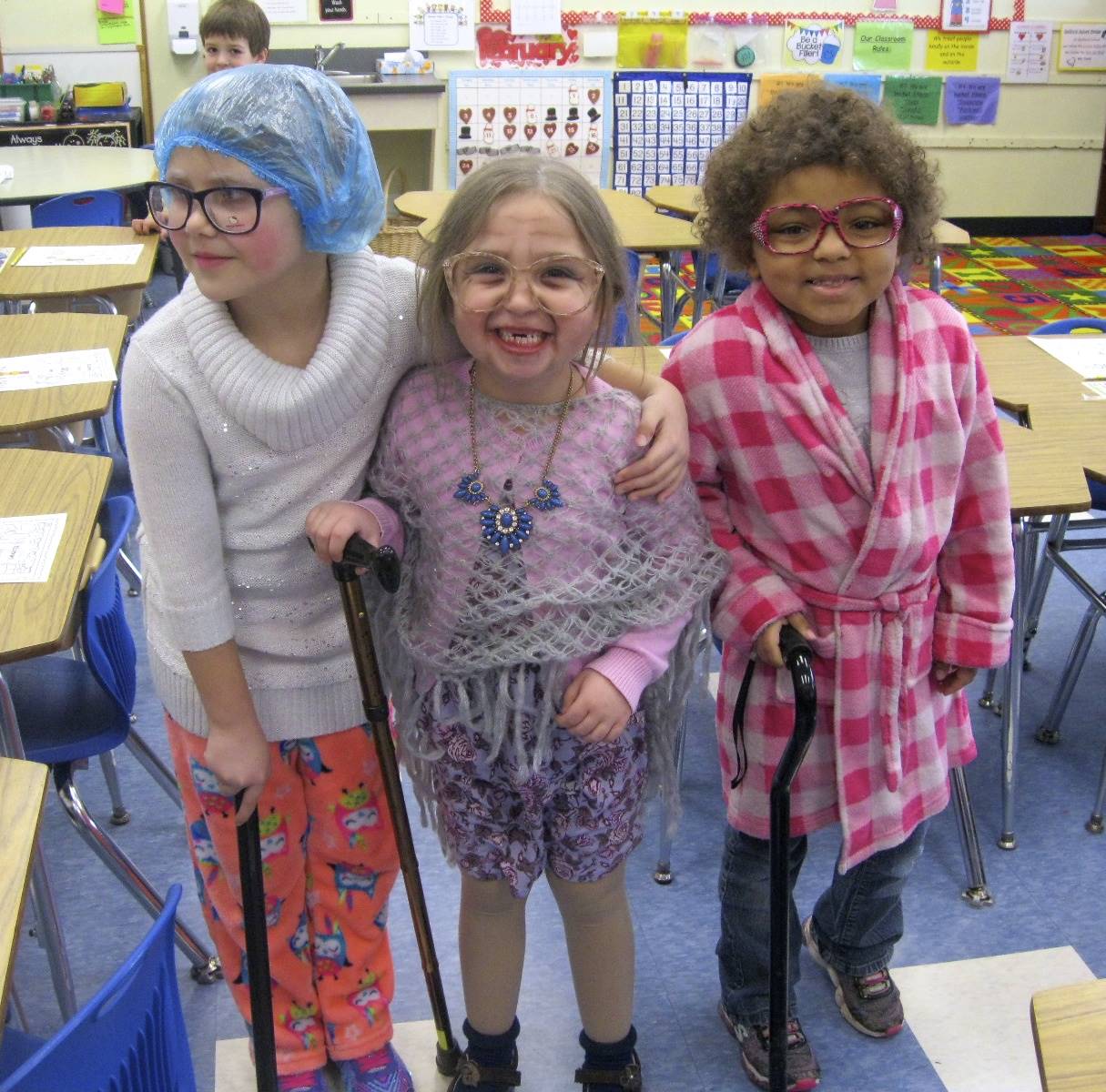 3 students dressed as 100 years old. 
