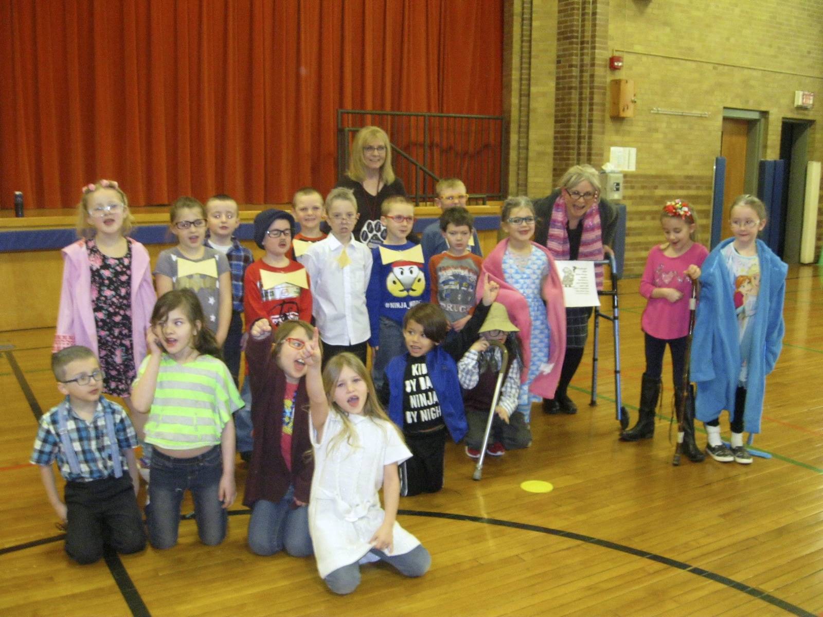 First grade teacher, aide and students on 100th day.