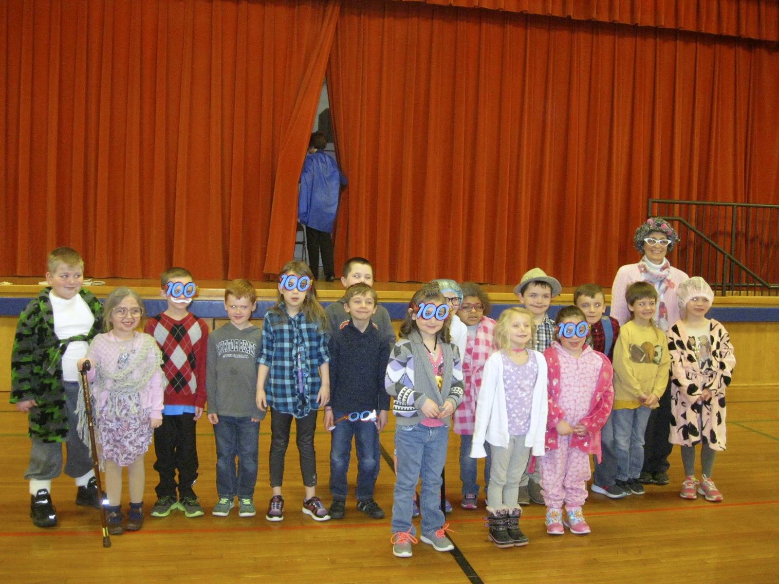 First grade teacher, aide and students on 100th day.