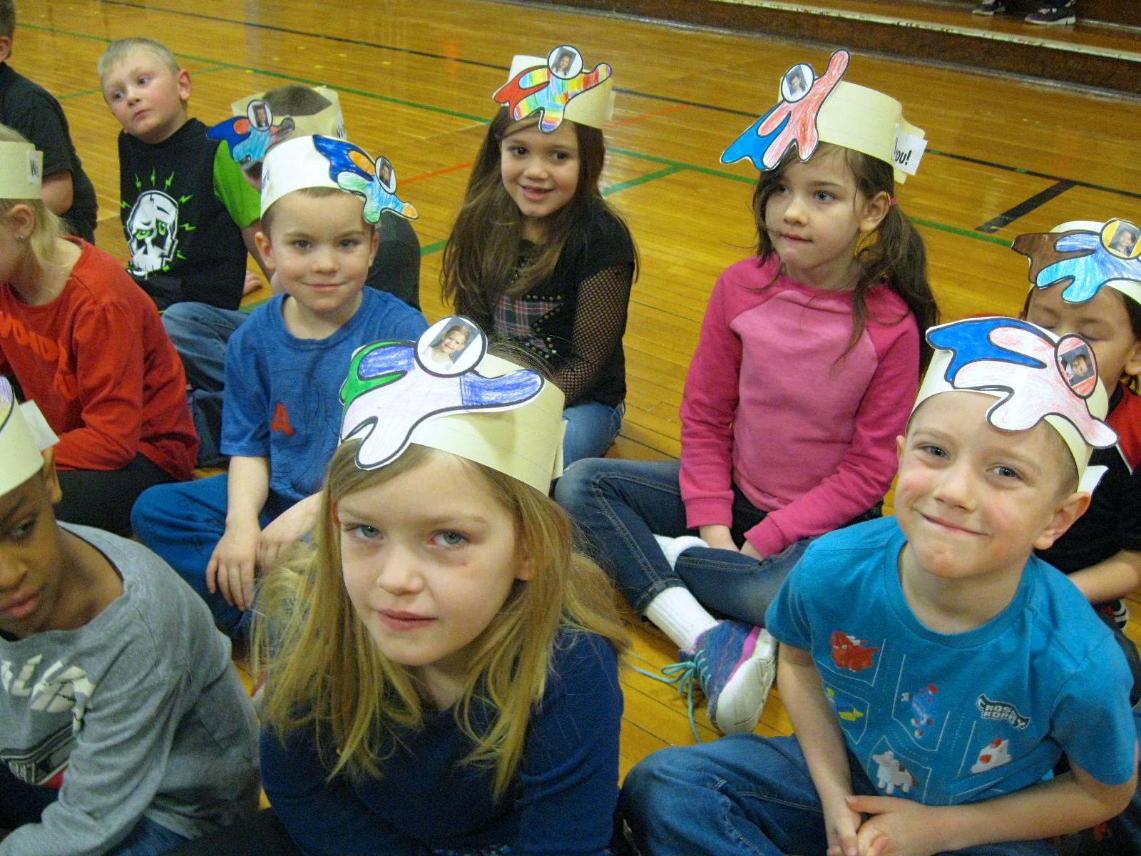 Students wearing superhero hats.