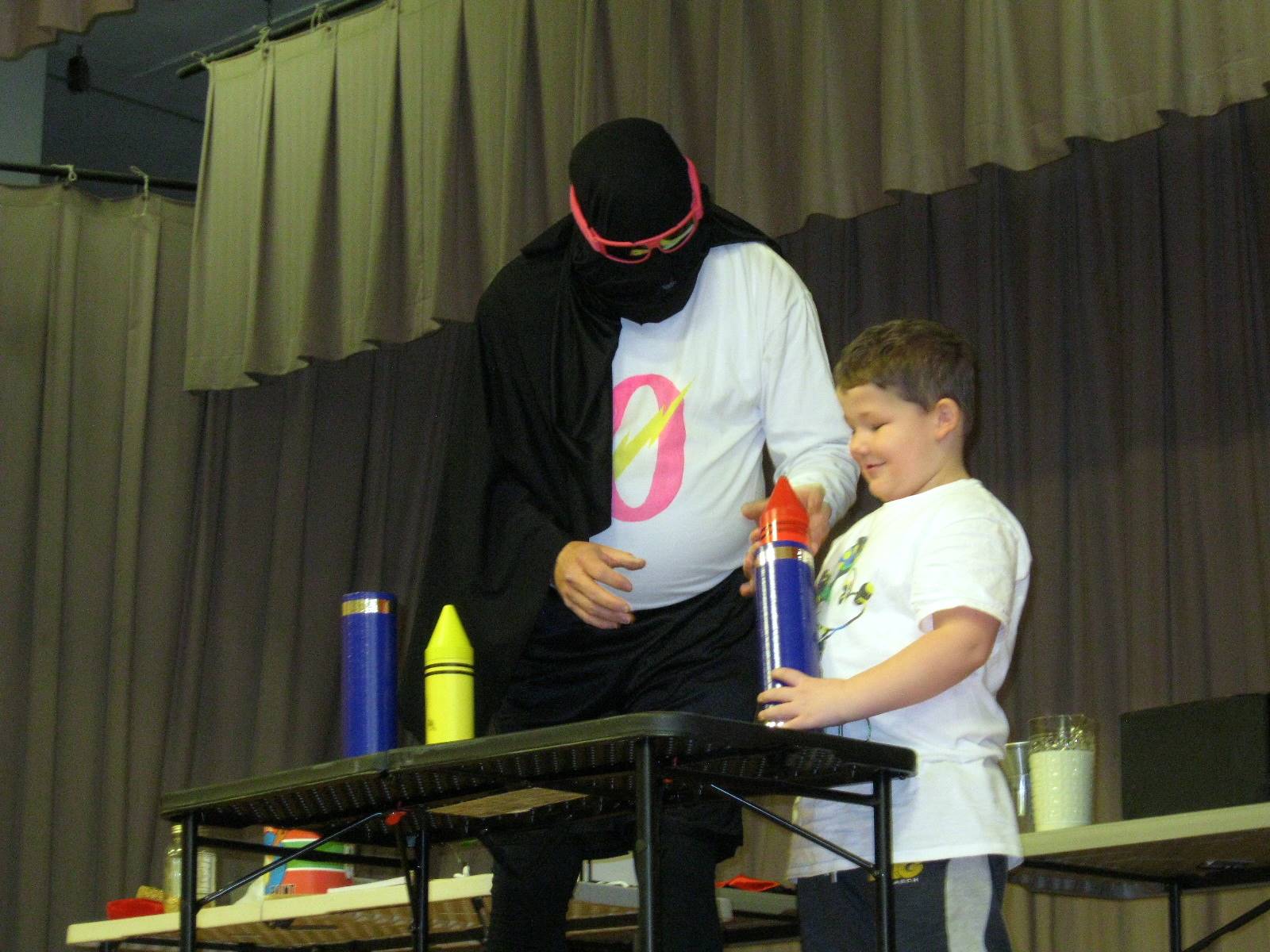 Zero the Hero and a student doing a magic trick.