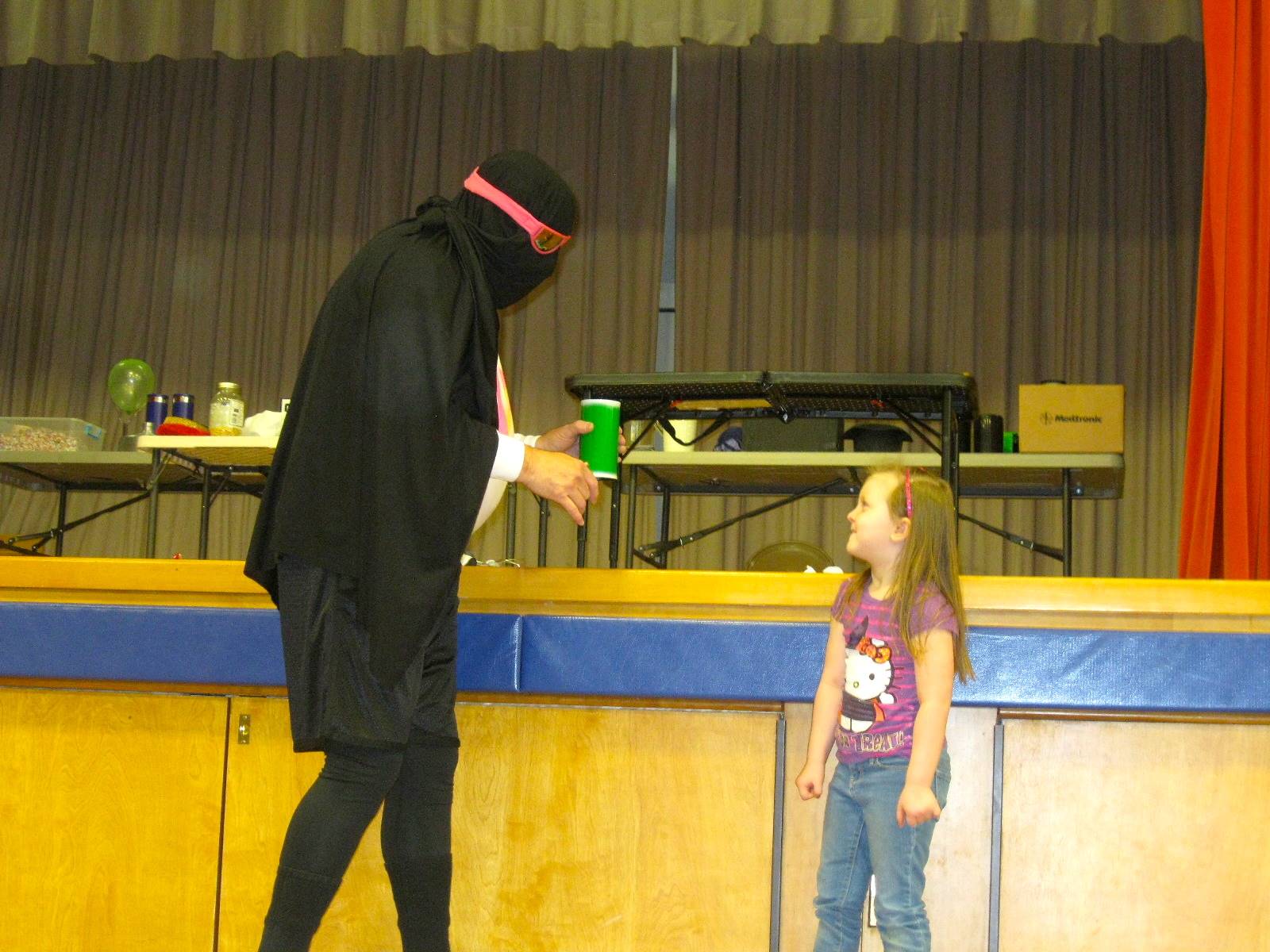 Zero shows the cup to a student.