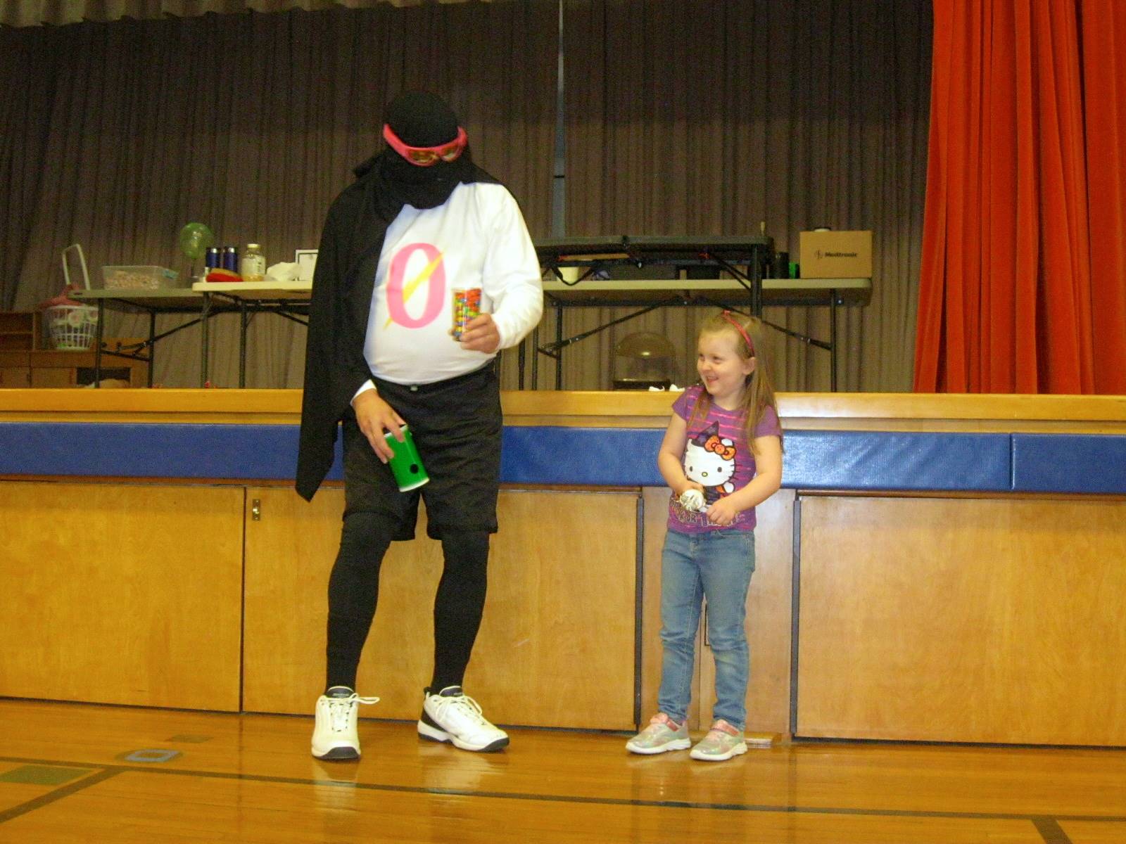 Zero the Hero and a student and a cup of candy.