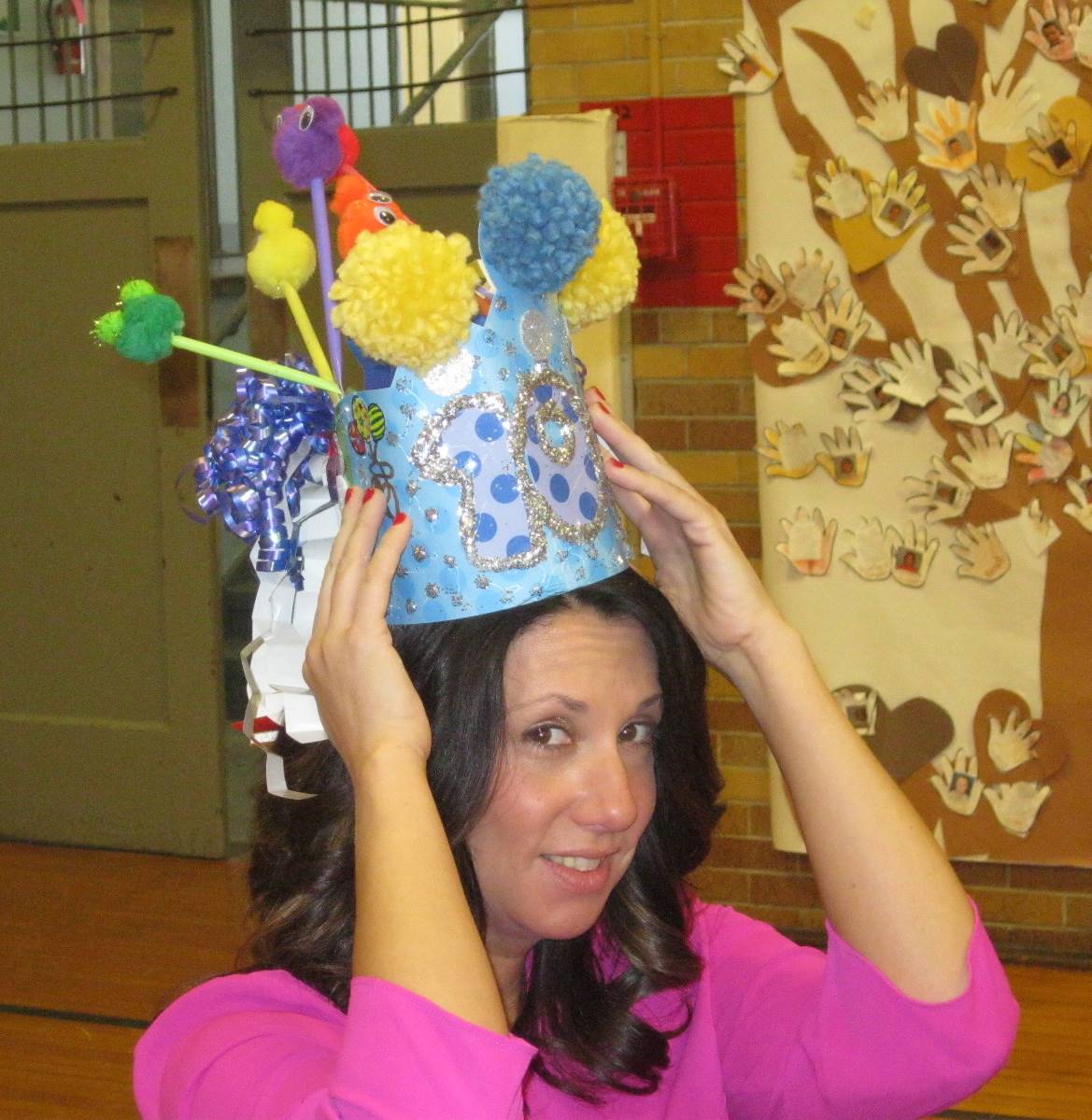 A teacher with a 100 day hat.