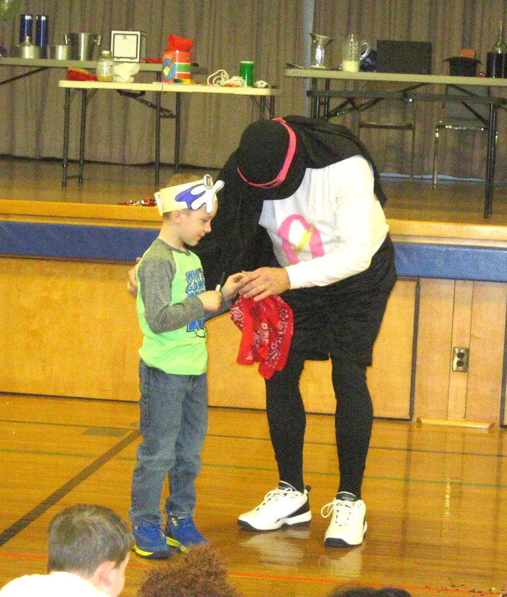 Zero the Hero and a student doing a magic trick.