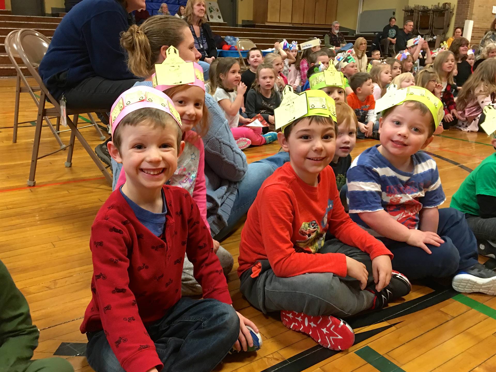 3 students wearing 100 hats.