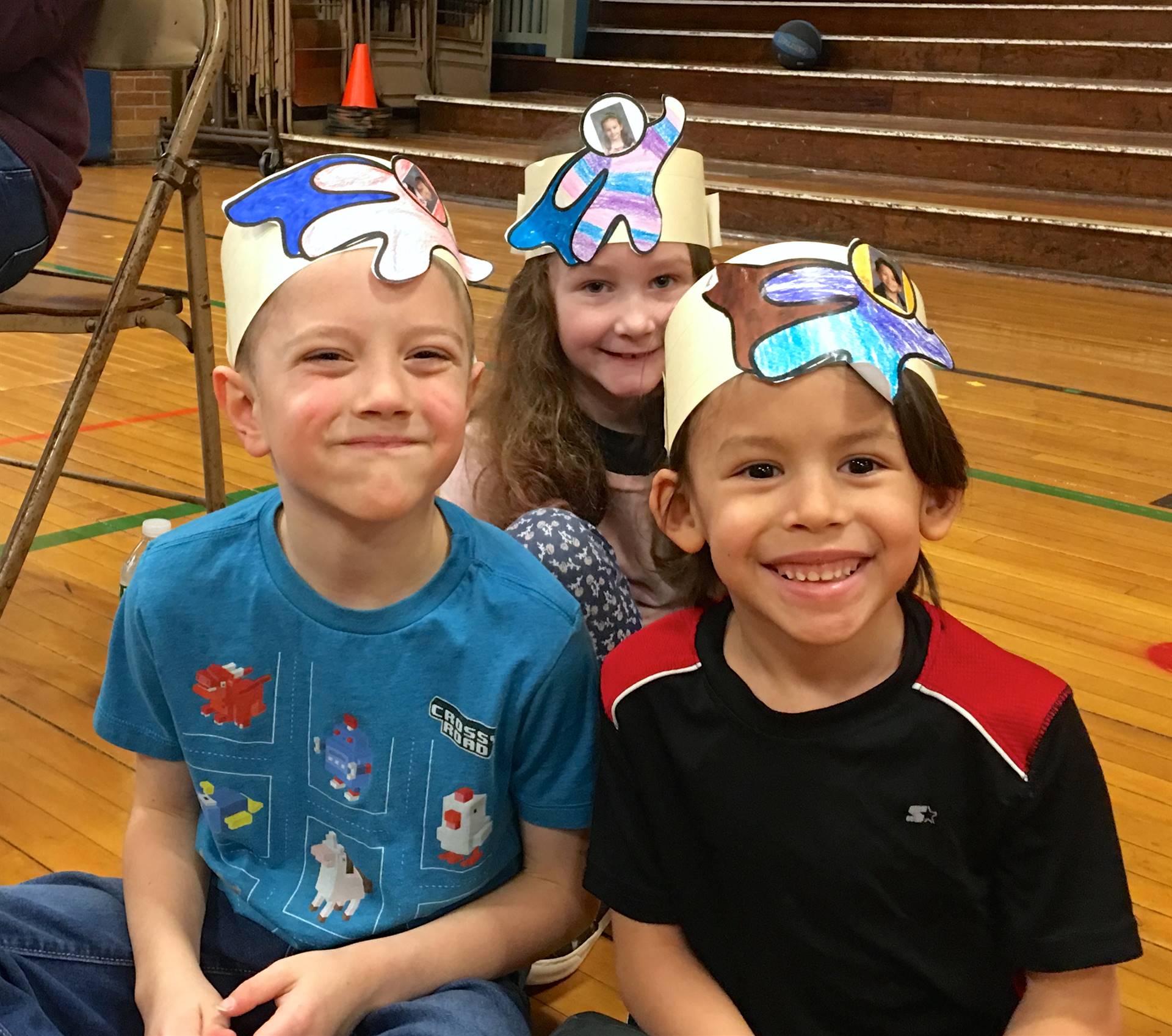 3 students wearing 100 hats.