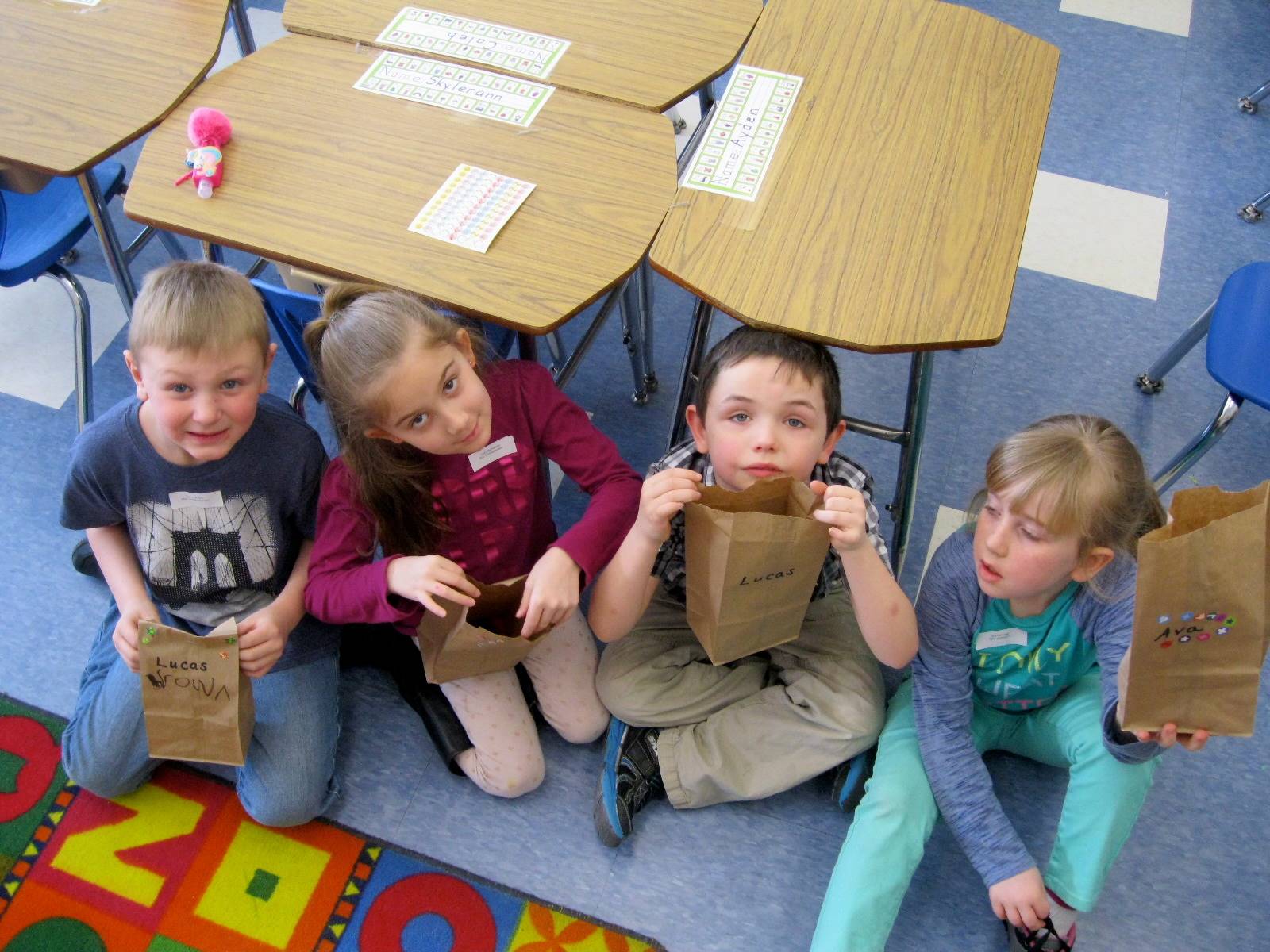 4 student with their bags filled with 100 treasures!