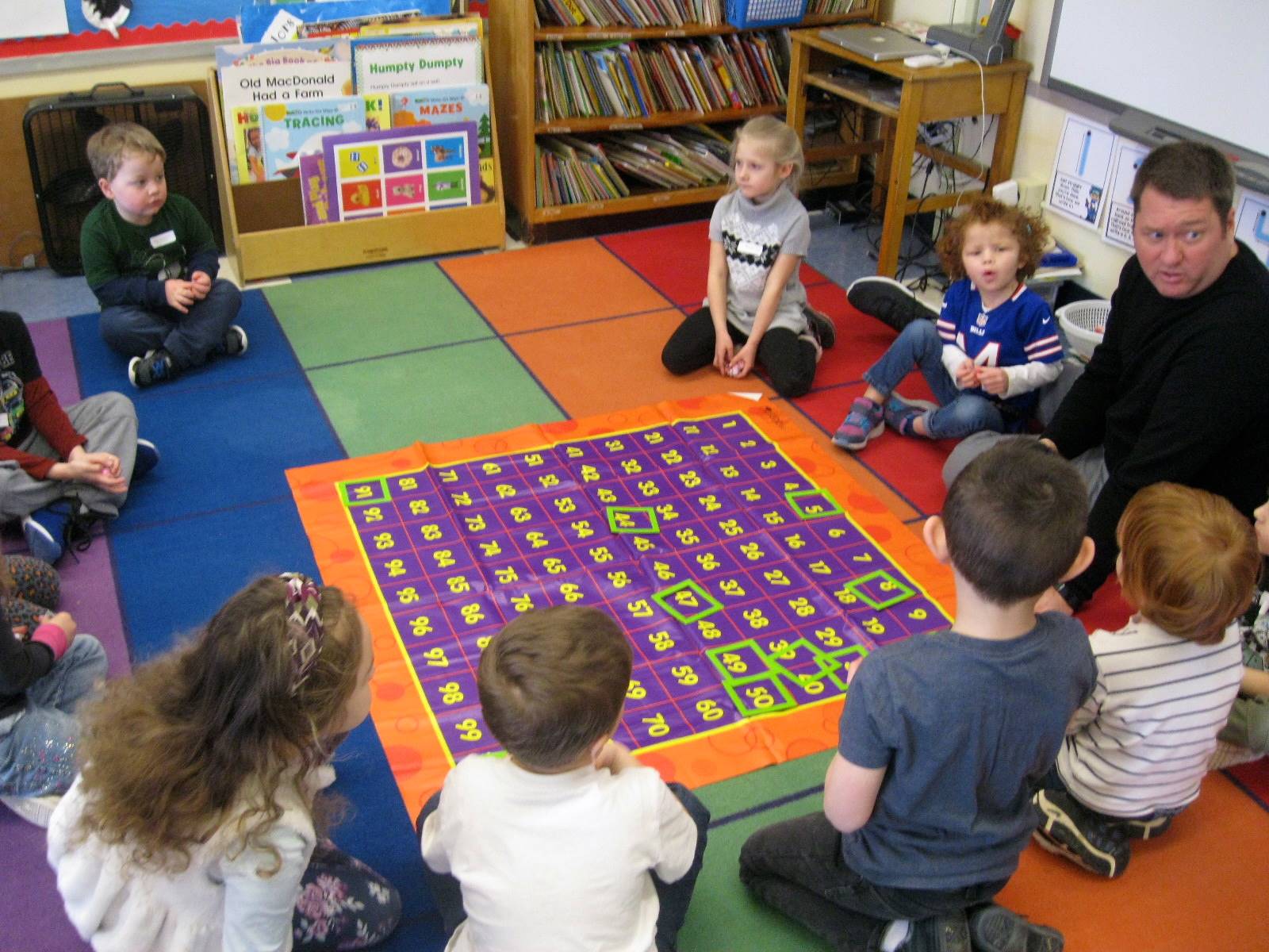 A teacher plays 100 day math game with students.