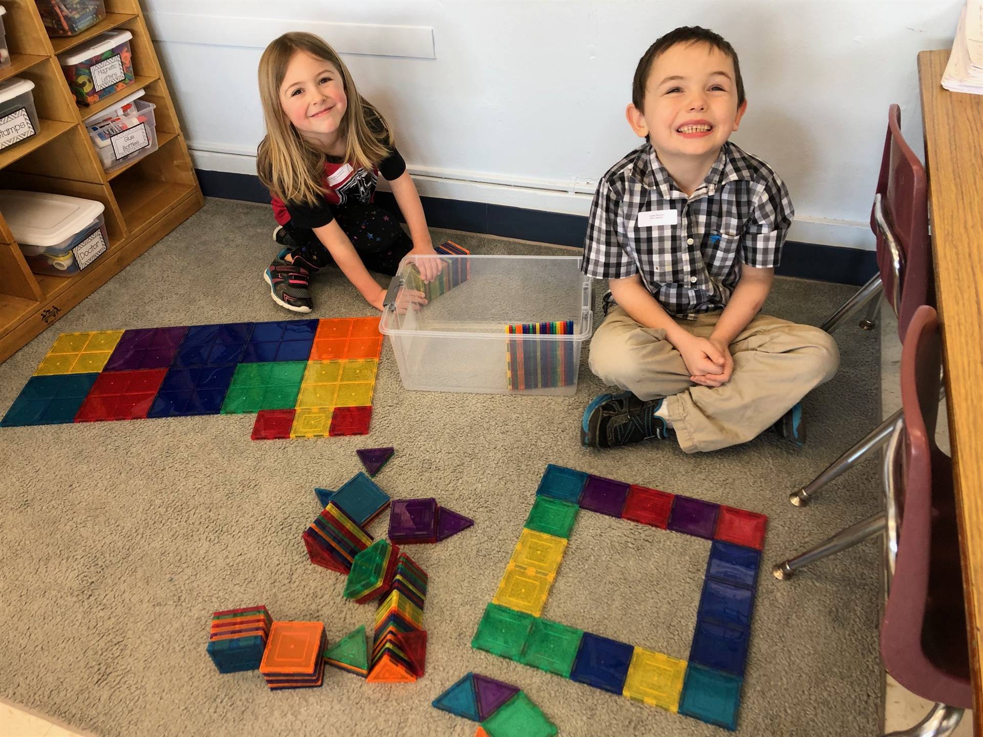2 students with their 100 magnetic creation.