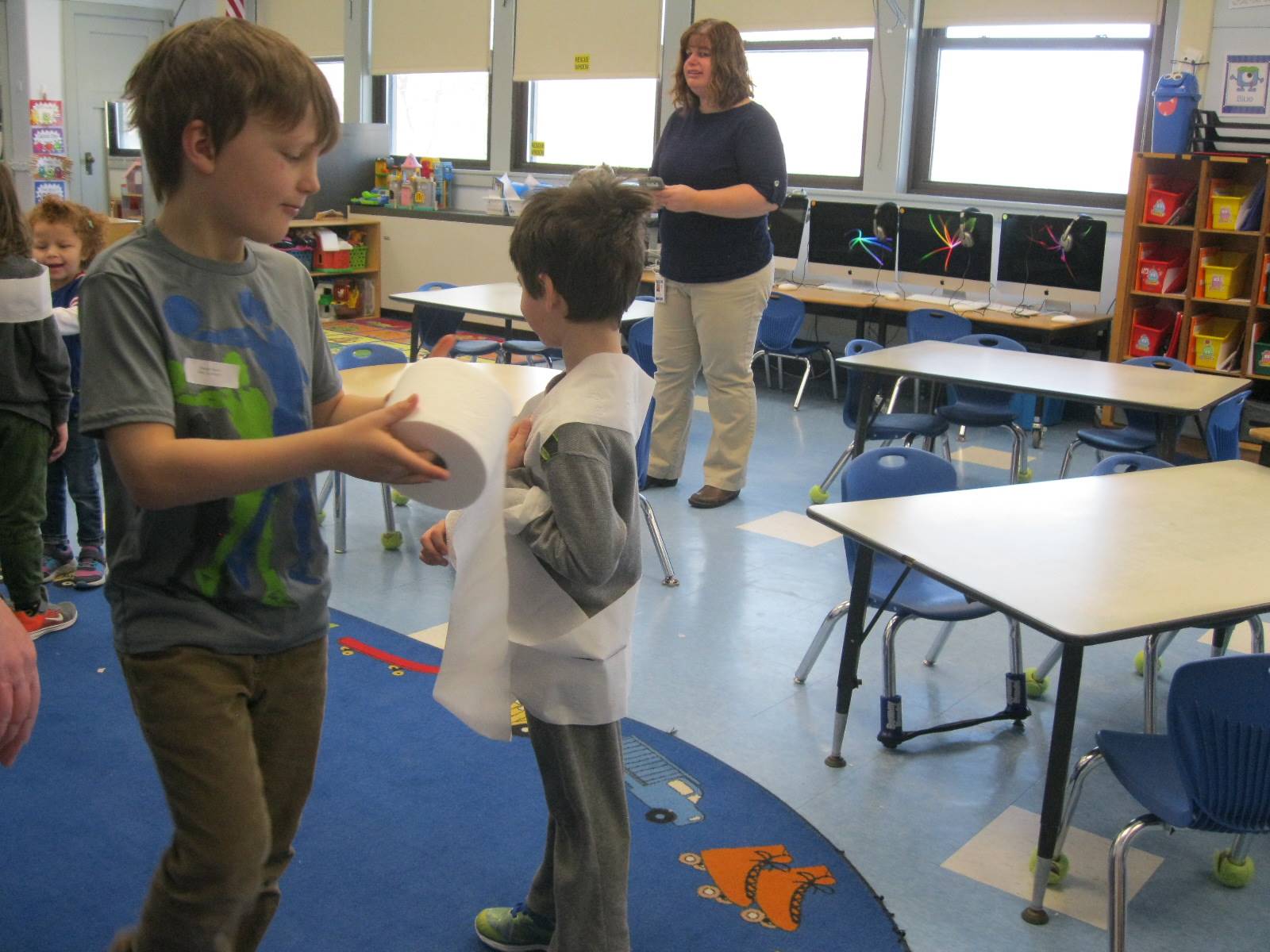 2 students playing a game with toilet paper