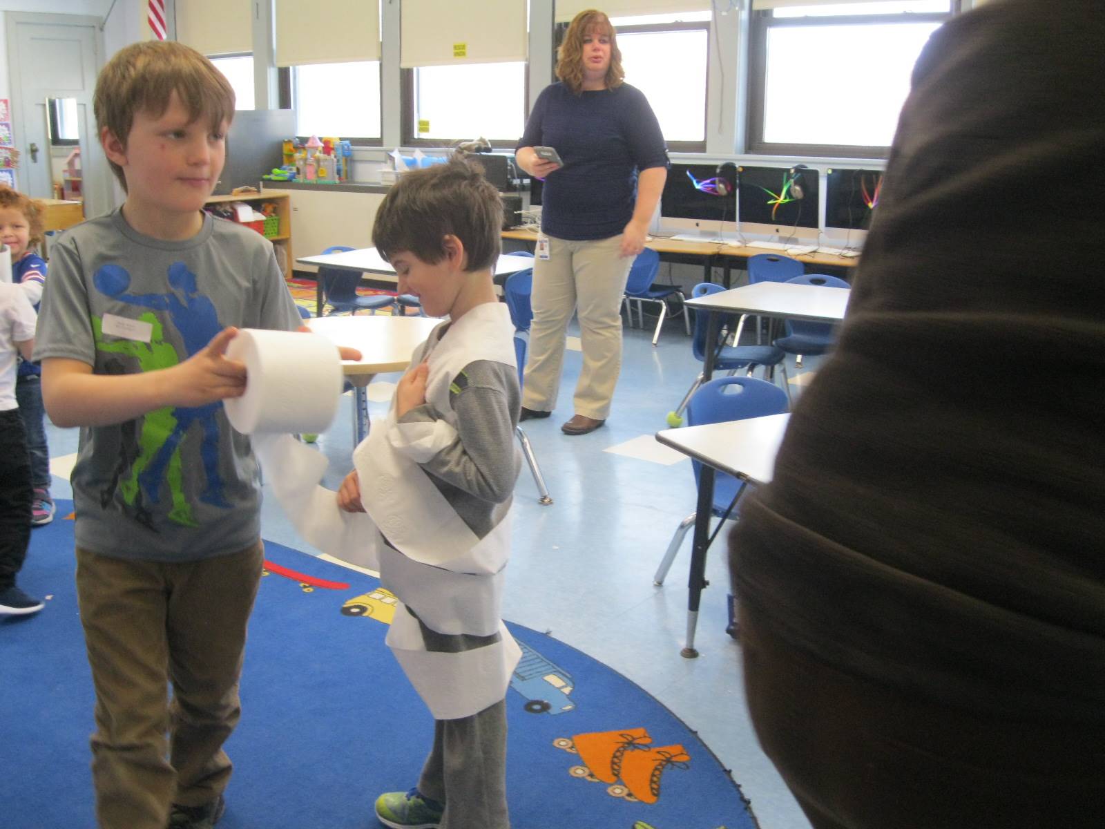 2 students playing a game with toilet paper