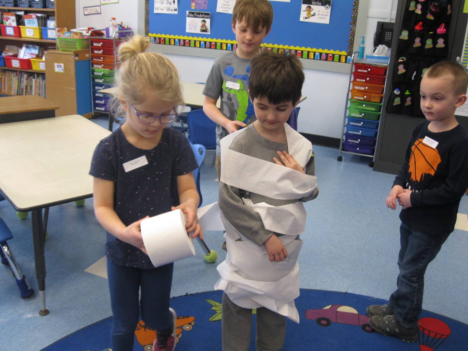 students playing a game with toilet paper
