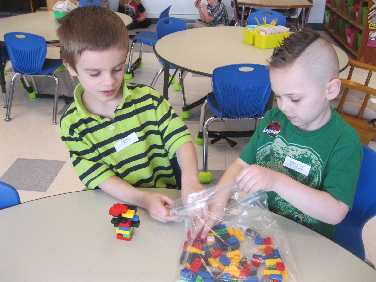 2 Students building with 100 legoes.