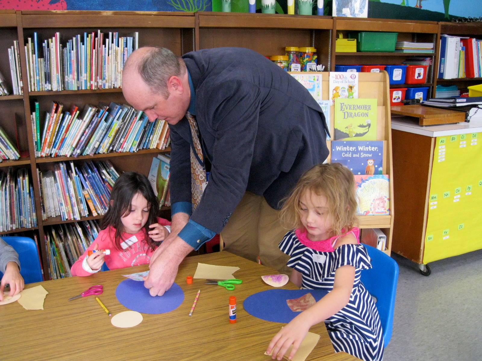 Mr. Ryan assisting students during 100th day activities