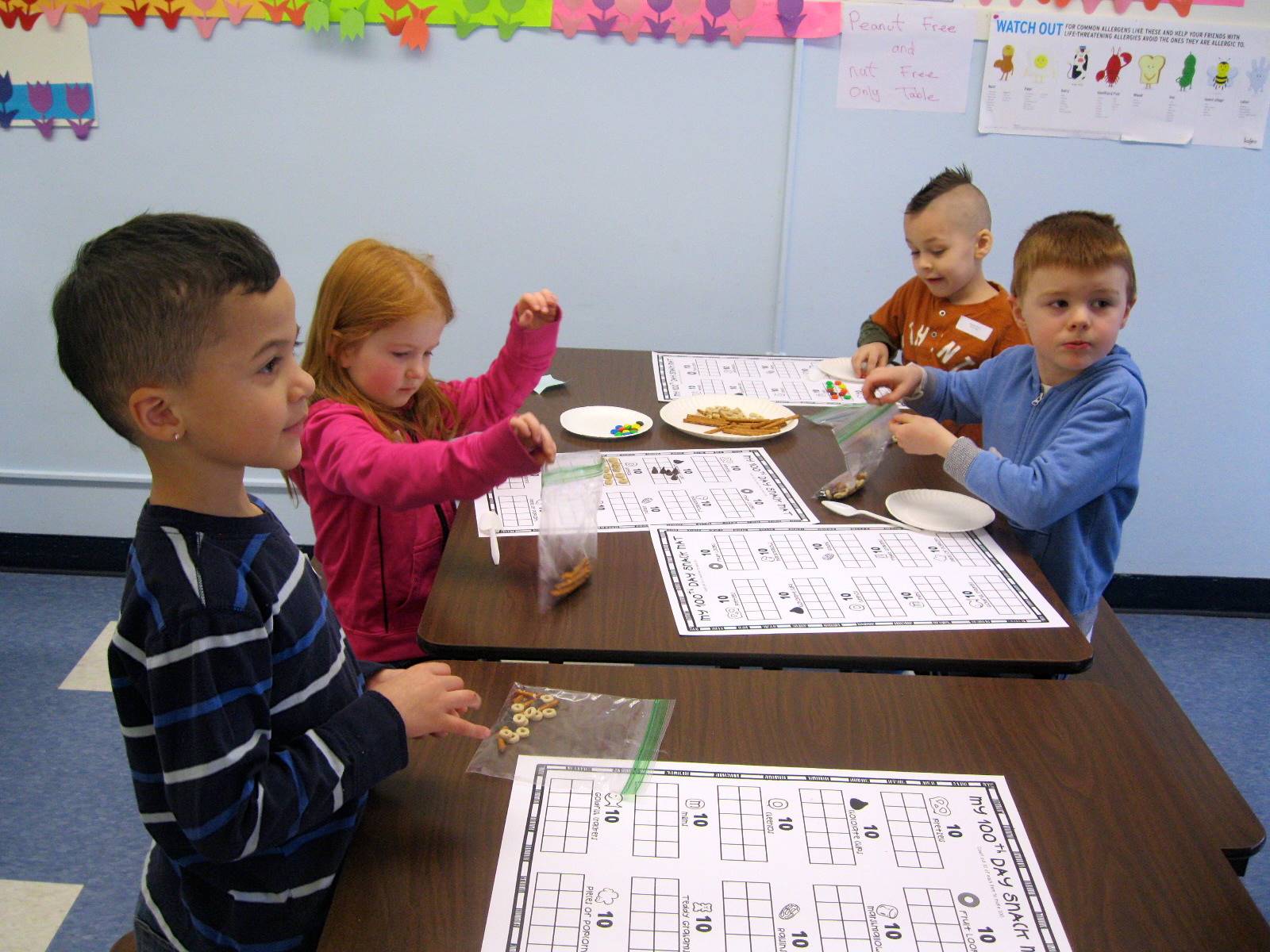 Students count 100 pieces of food for a trail mix.