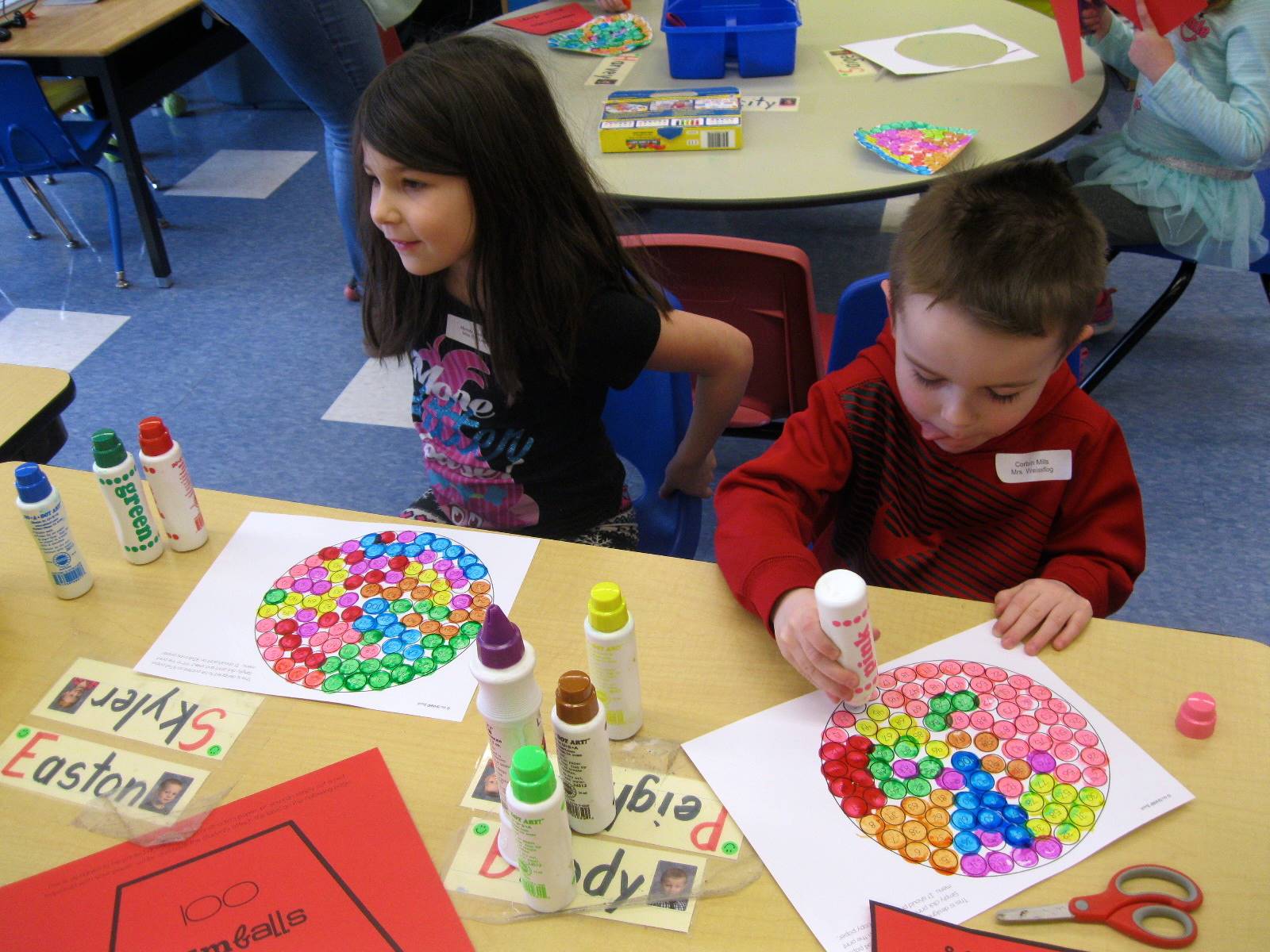 2 students paint 100 gum balls.
