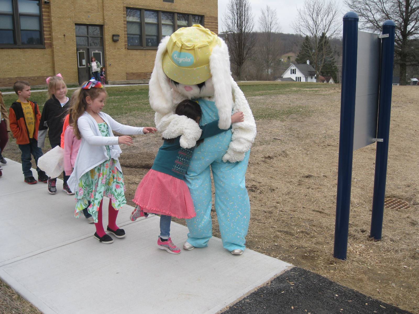 Students get a surprise greeting from Easter Bunny outside.