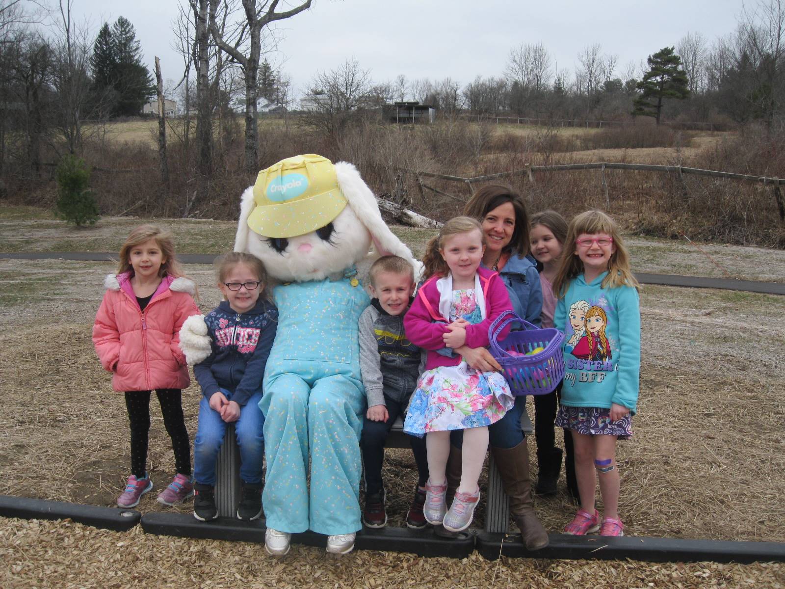 A group of students, a teacher, and the Easter Bunny.