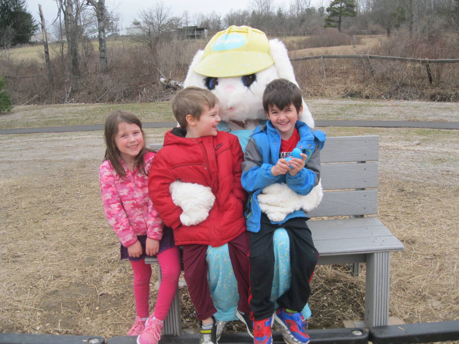 3 students "talk" with Easter Bunny.