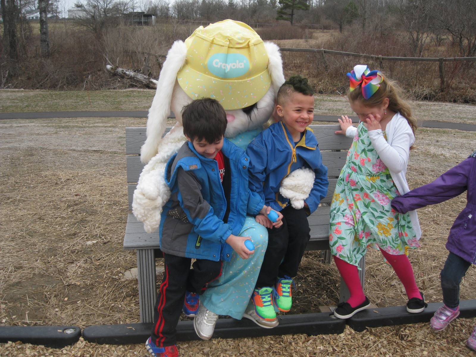3 students "talk" with Easter Bunny.